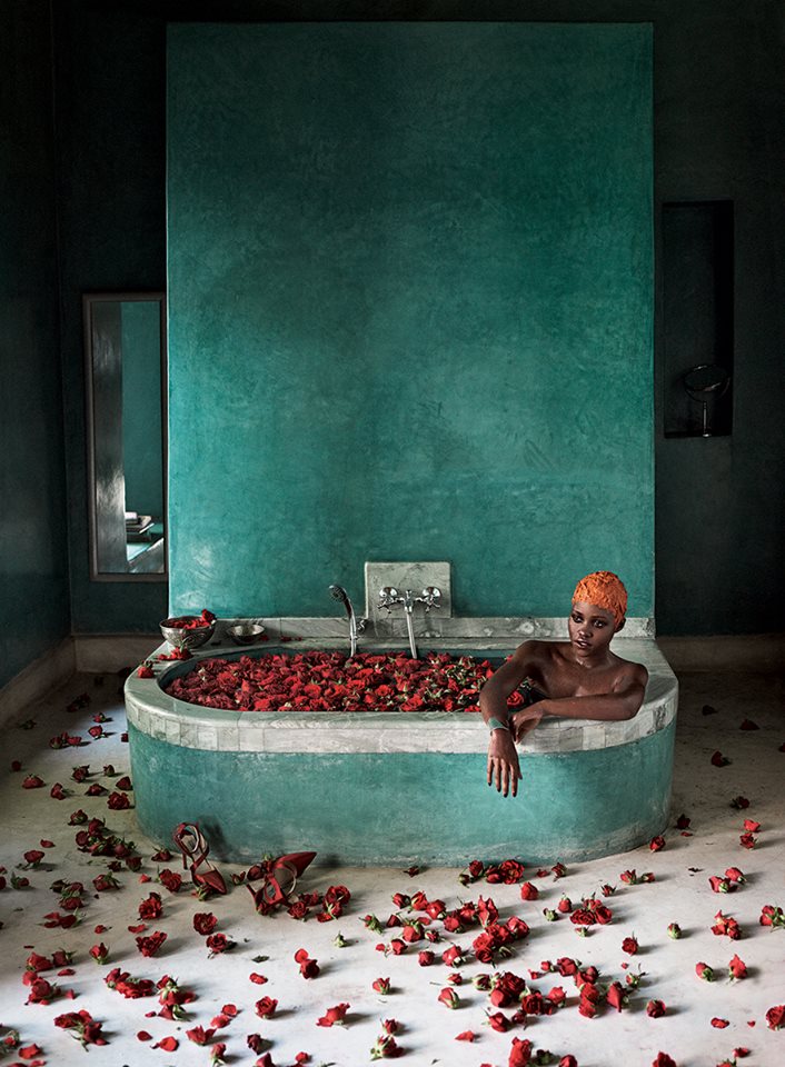  Water World:  “It just feels like the entertainment industry exploded into my life,” Nyong’o says, here soaking in a rose-filled bathtub at the hotel El Fenn. Janis by Janis Savitt silver cuff. Prada red satin heels.